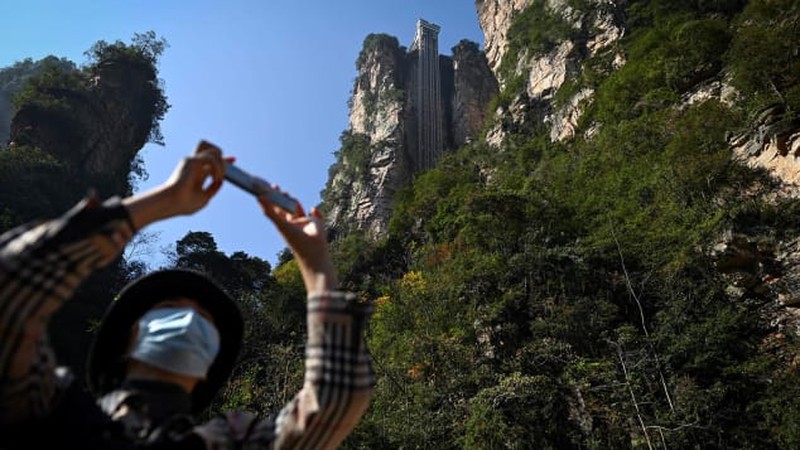 1158351748 Aerial view of the Bailong Elevator built on a cliff in Zhangjiajie in south China's Hunan province Friday, July 26, 2019. The three glass elevators are 335 meters tall, and take tourists 326 m upward with 172 m on the vertical cliff and 154 m inside the mountain. It was claimed to be the tallest outdoor elevator in the world whn opened to the public by 2002. (Photo credit should read FANG DONGXU/Future Publishing via Getty Images)