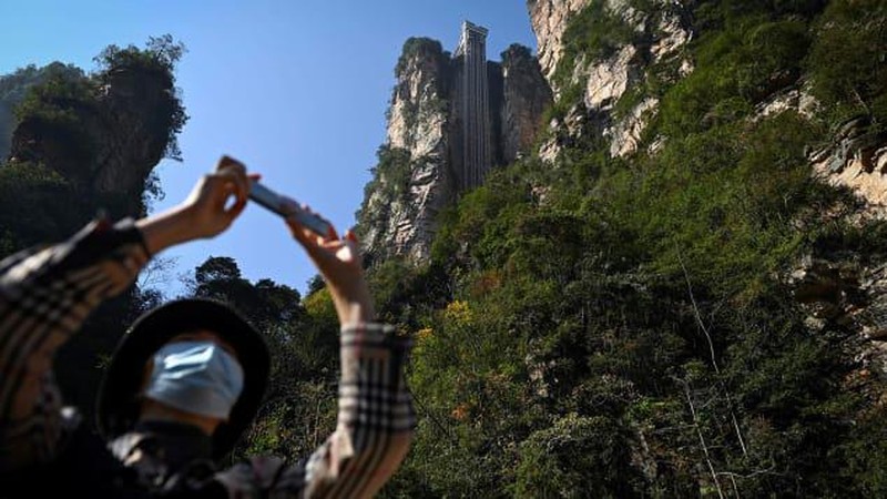 Aerial view of the Bailong Elevator built on a cliff in Zhangjiajie in south China's Hunan province Friday, July 26, 2019. The three glass elevators are 335 meters tall, and take tourists 326 m upward with 172 m on the vertical cliff and 154 m inside the mountain. It was claimed to be the tallest outdoor elevator in the world whn opened to the public by 2002. (Photo credit should read FANG DONGXU/Future Publishing via Getty Images)