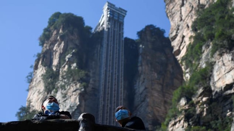 1158351748 Aerial view of the Bailong Elevator built on a cliff in Zhangjiajie in south China's Hunan province Friday, July 26, 2019. The three glass elevators are 335 meters tall, and take tourists 326 m upward with 172 m on the vertical cliff and 154 m inside the mountain. It was claimed to be the tallest outdoor elevator in the world whn opened to the public by 2002. (Photo credit should read FANG DONGXU/Future Publishing via Getty Images)