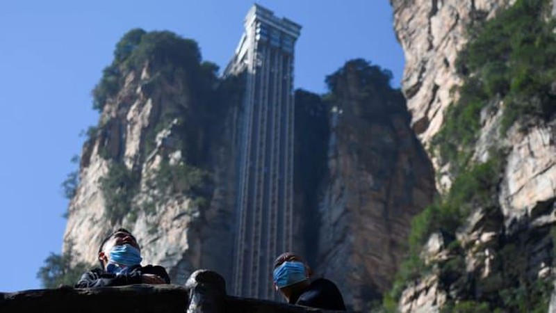 Aerial view of the Bailong Elevator built on a cliff in Zhangjiajie in south China's Hunan province Friday, July 26, 2019. The three glass elevators are 335 meters tall, and take tourists 326 m upward with 172 m on the vertical cliff and 154 m inside the mountain. It was claimed to be the tallest outdoor elevator in the world whn opened to the public by 2002. (Photo credit should read FANG DONGXU/Future Publishing via Getty Images)