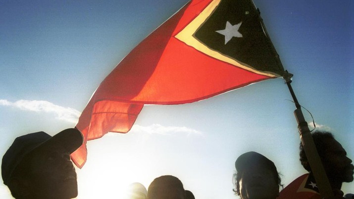 405552 05: People wave the East Timorese flag during independence day celebrations May 19, 2002 in Dili, East Timor. East Timor formally declared independence and became the world's newest nation when the United Nations transferred political power to the democratically elected government. (Photo by Edy Purnomo/Getty Images)