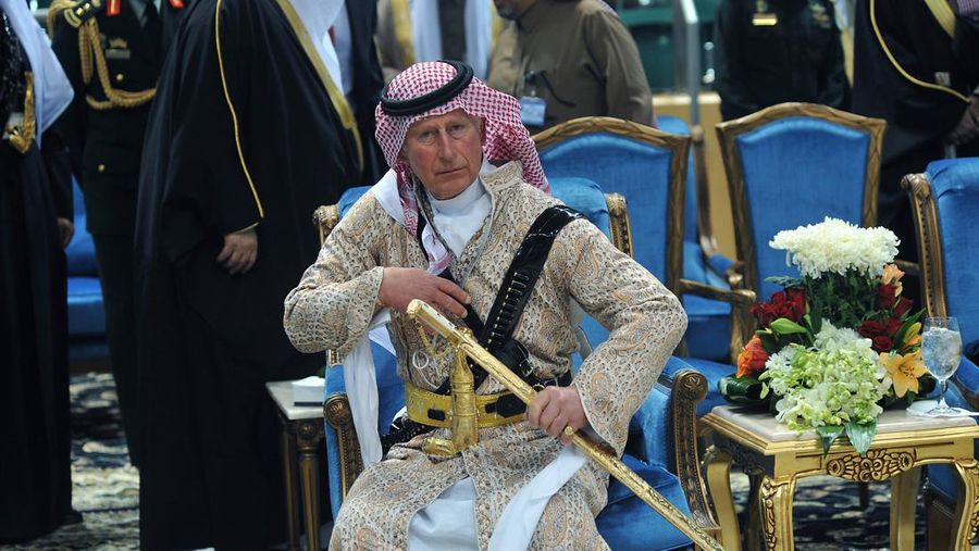 FILE - In this Feb. 18, 2014 file photo, Britain's Prince Charles wears a traditional Saudi uniform as he attends the traditional Saudi dancing best known as 