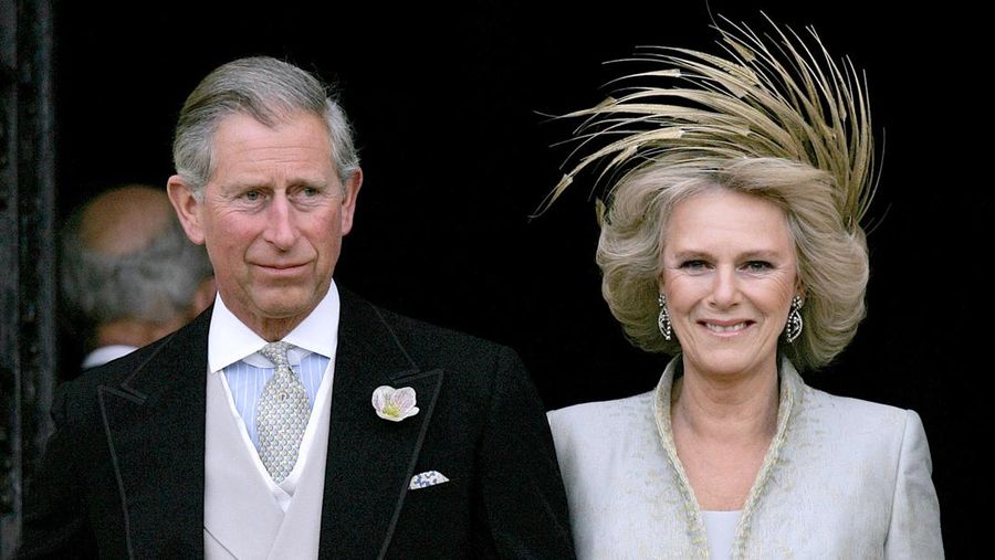 FILE - In this Saturday, April 9, 2005 file photo, Britain's Prince Charles and his bride Camilla Duchess of Cornwall leave St George's Chapel in Windsor, England following the church blessing of their civil wedding ceremony.  Prince Charles has been preparing for the crown his entire life. Now, that moment has finally arrived. Charles, the oldest person to ever assume the British throne, became king on Thursday Sept. 8, 2022, following the death of his mother, Queen Elizabeth II. (AP Photo/ Alastair Grant, Pool, File)