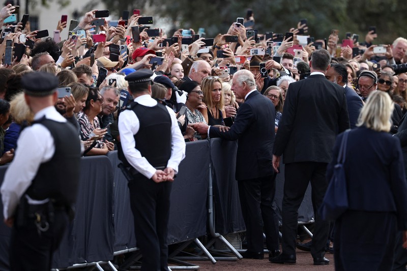 Britain's King Charles and Queen Camilla walk outside Buckingham Palace, following the passing of Britain's Queen Elizabeth, in London, Britain, September 9, 2022. REUTERS/Henry Nicholls
