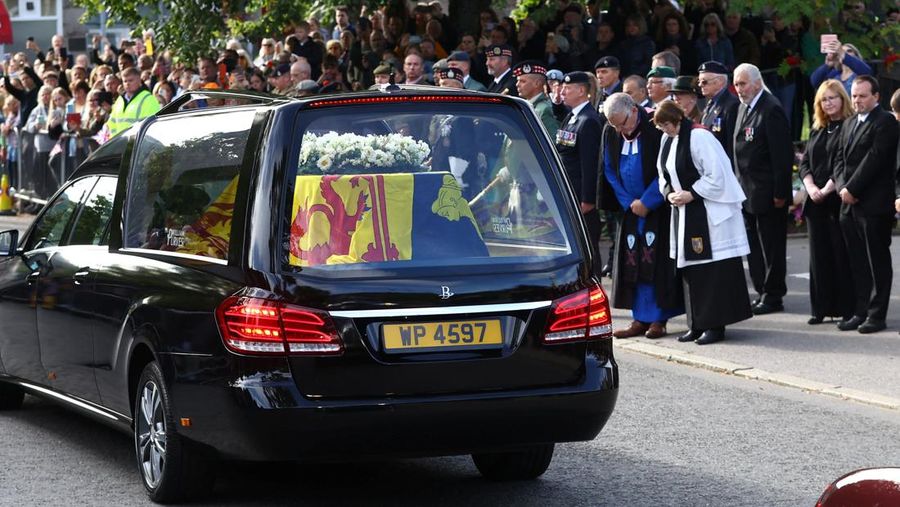 Mobil jenazah membawa peti mati Ratu Elizabeth II yang ditutupi Standar Kerajaan untuk Skotlandia dan karangan bunga meninggalkan Kastil Balmoral, di Balmoral, Skotlandia, Inggris, Minggu (11/9/2022). Peti mati ratu akan dibawa sejauh 290 km melalui jalan darat dari perkebunan terpencil ke Istana Holyroodhouse di Edinburgh. (Photo by Owen Humphreys/PA Images via Getty Images)