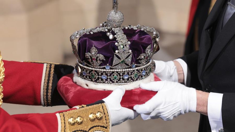 The Imperial State Crown arrives through the Sovereign's Entrance ahead of the State Opening of Parliament at Houses of Parliament in London, Tuesday, May 10, 2022. Britain’s Parliament opens a new year-long session on Tuesday with a mix of royal pomp and raw politics, as Prime Minister Boris Johnson tries to re-energize his scandal-tarnished administration and revive the economy amid a worsening cost-of-living crisis. (Chris Jackson/Pool Photo via AP)