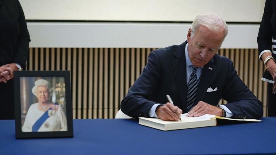 President Joe Biden signs a condolence book at the British Embassy in Washington, Thursday, Sept. 8, 2022, for Queen Elizabeth II, Britain's longest-reigning monarch and a rock of stability across much of a turbulent century, who died Thursday after 70 years on the throne. She was 96. (AP Photo/Susan Walsh)