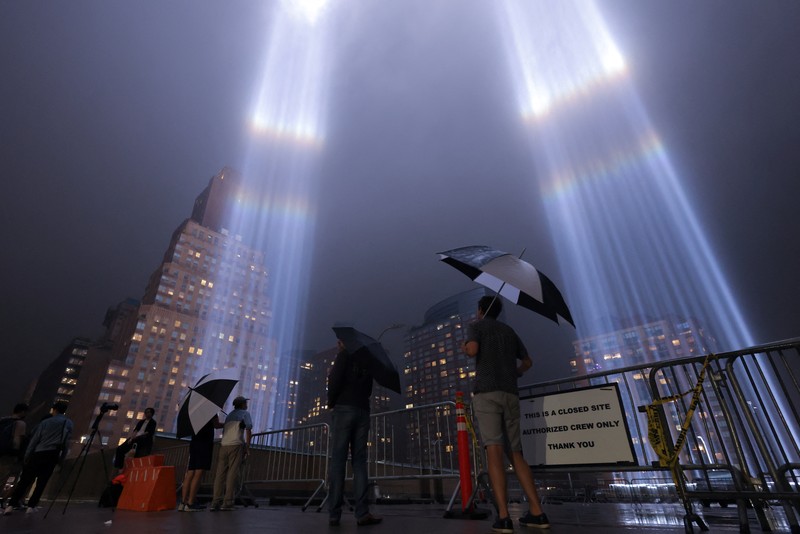 USA-SEPT11/ A person looks toward the Tribute in Light for the remembrance of the 21st anniversary of the September 11, 2001 attacks in Manhattan, New York City, U.S., September 11, 2022. REUTERS/Andrew Kelly