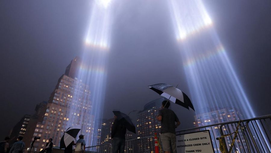 A person looks toward the Tribute in Light for the remembrance of the 21st anniversary of the September 11, 2001 attacks in Manhattan, New York City, U.S., September 11, 2022.  REUTERS/Andrew Kelly