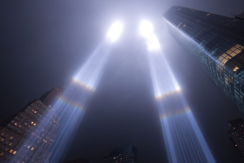 A person looks toward the Tribute in Light for the remembrance of the 21st anniversary of the September 11, 2001 attacks in Manhattan, New York City, U.S., September 11, 2022.  REUTERS/Andrew Kelly