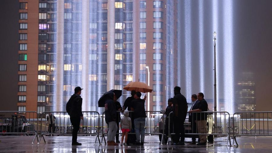 A person looks toward the Tribute in Light for the remembrance of the 21st anniversary of the September 11, 2001 attacks in Manhattan, New York City, U.S., September 11, 2022.  REUTERS/Andrew Kelly
