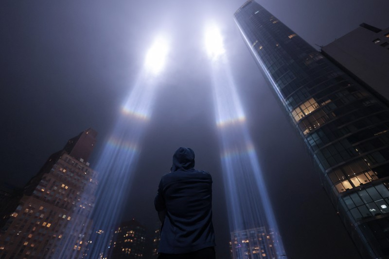 USA-SEPT11/ A person looks toward the Tribute in Light for the remembrance of the 21st anniversary of the September 11, 2001 attacks in Manhattan, New York City, U.S., September 11, 2022. REUTERS/Andrew Kelly