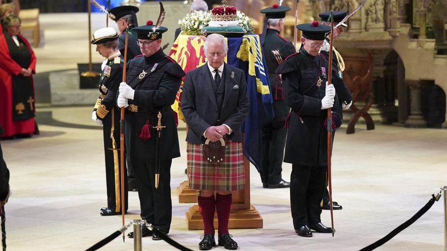 Britain's King Charles III, center, and other members of the royal family hold a vigil at the coffin of Queen Elizabeth II at St Giles' Cathedral, Edinburgh, Scotland,  Monday Sept. 12, 2022. (Jane Barlow/Pool via AP)