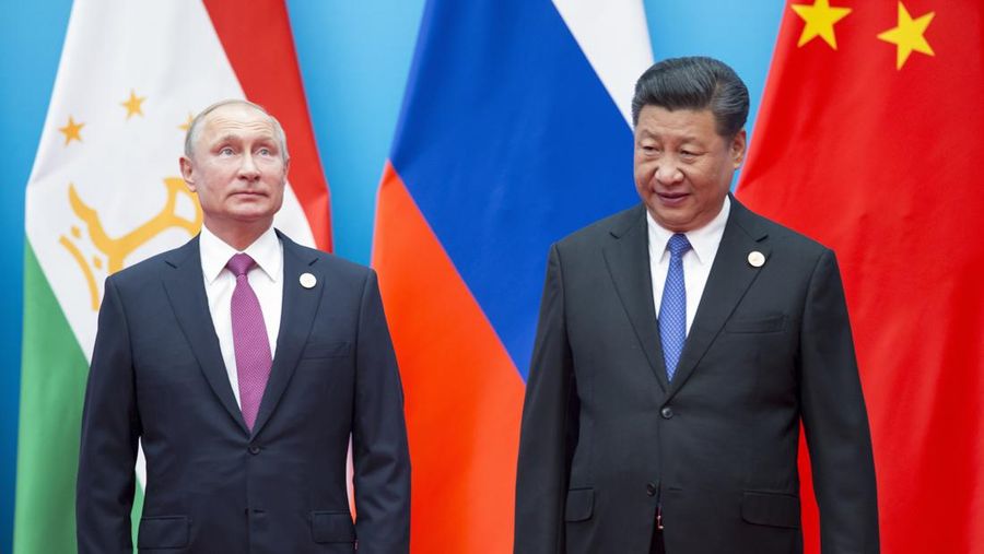 FILE - Chinese President Xi Jinping, right, and Russian President Vladimir Putin pose for a photo at the Shanghai Cooperation Organization (SCO) Summit in Qingdao in eastern China's Shandong Province on June 10, 2018. President Xi Jinping is using his first trip abroad since the start of the pandemic to promote China's strategic ambitions at a summit with Putin and other leaders of a Central Asian security group. (AP Photo/Alexander Zemlianichenko, File)
