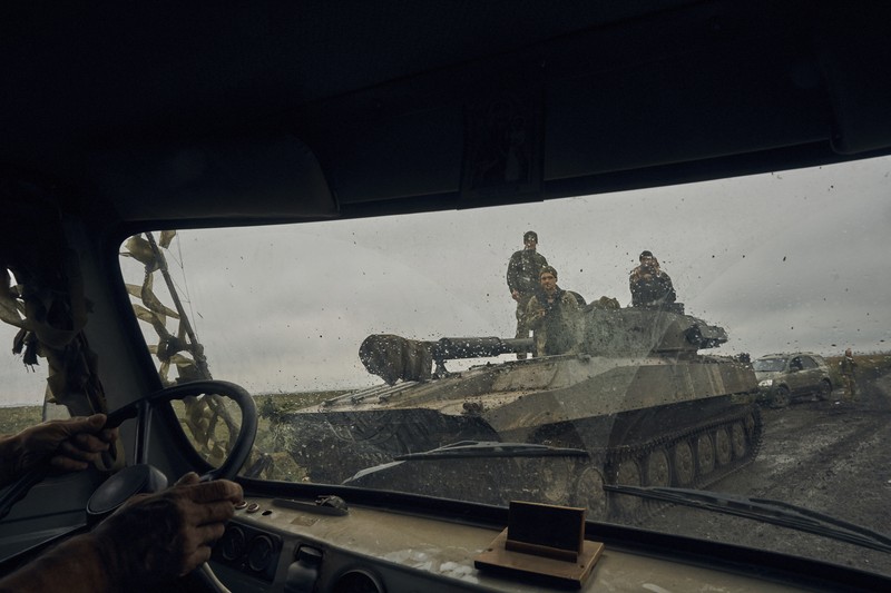 A Ukrainian soldier smiles from a military vehicle on the road in the freed territory in the Kharkiv region, Ukraine, Monday, Sept. 12, 2022. Ukrainian troops retook a wide swath of territory from Russia on Monday, pushing all the way back to the northeastern border in some places, and claimed to have captured many Russian soldiers as part of a lightning advance that forced Moscow to make a hasty retreat. (AP Photo/Kostiantyn Liberov)