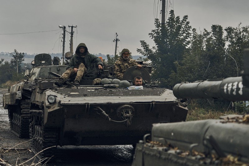 APTOPIX Russia Ukraine War A Ukrainian soldier smiles from a military vehicle on the road in the freed territory in the Kharkiv region, Ukraine, Monday, Sept. 12, 2022. Ukrainian troops retook a wide swath of territory from Russia on Monday, pushing all the way back to the northeastern border in some places, and claimed to have captured many Russian soldiers as part of a lightning advance that forced Moscow to make a hasty retreat. (AP Photo/Kostiantyn Liberov)