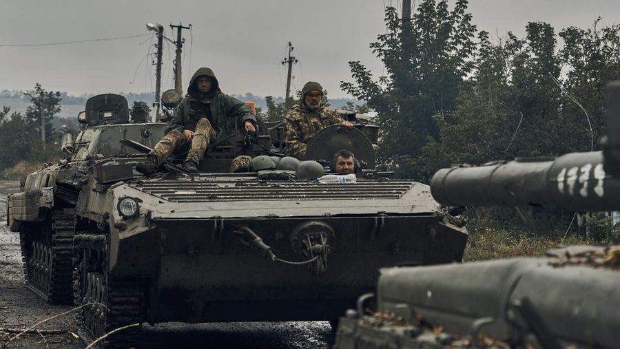 Ukrainian military vehicles move on the road in the freed territory in the Kharkiv region, Ukraine, Monday, Sept. 12, 2022. Ukrainian troops retook a wide swath of territory from Russia on Monday, pushing all the way back to the northeastern border in some places, and claimed to have captured many Russian soldiers as part of a lightning advance that forced Moscow to make a hasty retreat. (AP Photo/Kostiantyn Liberov)
