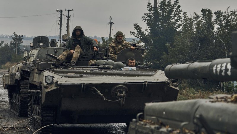 A Ukrainian soldier smiles from a military vehicle on the road in the freed territory in the Kharkiv region, Ukraine, Monday, Sept. 12, 2022. Ukrainian troops retook a wide swath of territory from Russia on Monday, pushing all the way back to the northeastern border in some places, and claimed to have captured many Russian soldiers as part of a lightning advance that forced Moscow to make a hasty retreat. (AP Photo/Kostiantyn Liberov)
