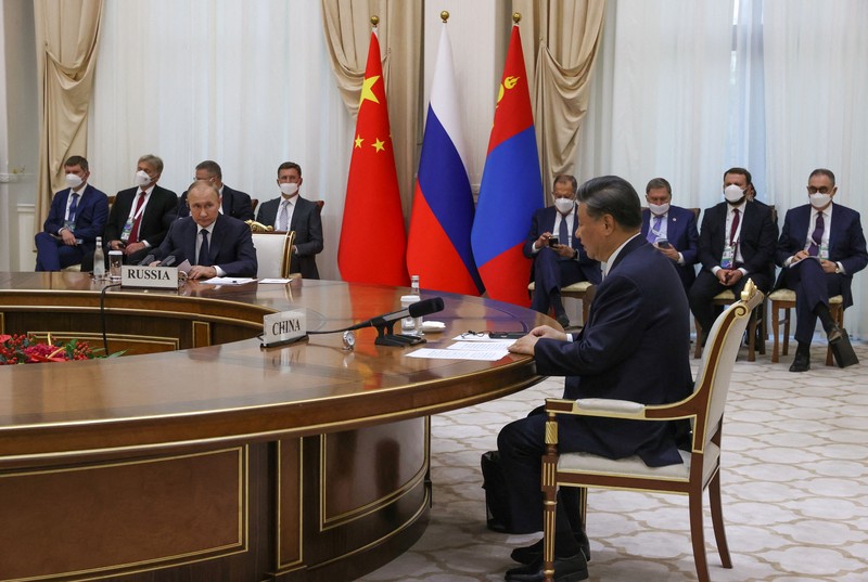 China's President Xi Jinping and Russian President Vladimir Putin pose with Mongolia's President during their trilateral meeting on the sidelines of the Shanghai Cooperation Organisation (SCO) leaders' summit in Samarkand on September 15, 2022. (Photo by Alexandr Demyanchuk / SPUTNIK / AFP) (Photo by ALEXANDR DEMYANCHUK/SPUTNIK/AFP via Getty Images)