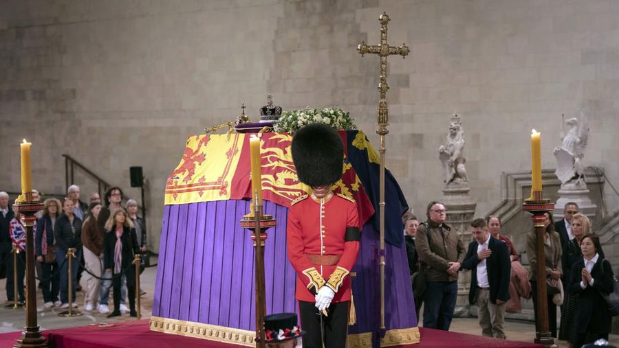 Members of the public file past the coffin of Queen Elizabeth II, draped in the Royal Standard with the Imperial State Crown and the Sovereign's orb and sceptre, lying in state on the catafalque in Westminster Hall, at the Palace of Westminster, in London, Thursday, Sept. 15, 2022, ahead of her funeral on Monday. (Danny Lawson/Pool Photo via AP)