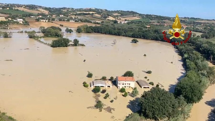 Rescue workers arrive on a dinghy boat on a flooded street after heavy rains hit the east coast of Marche region in Senigallia, Italy, September 16, 2022. Vigili del Fuoco/Handout via REUTERS ATTENTION EDITORS THIS IMAGE HAS BEEN SUPPLIED BY A THIRD PARTY. DO NOT OBSCURE LOGO.