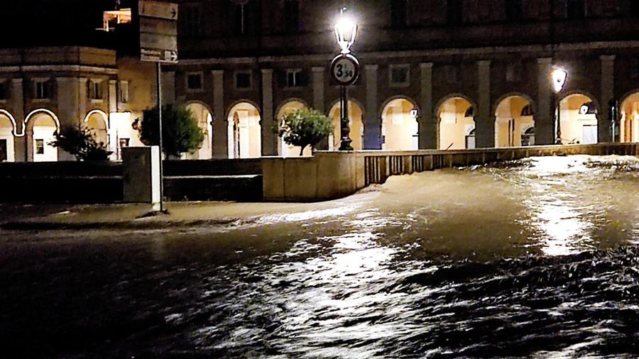 Rescue workers arrive on a dinghy boat on a flooded street after heavy rains hit the east coast of Marche region in Senigallia, Italy, September 16, 2022. Vigili del Fuoco/Handout via REUTERS ATTENTION EDITORS THIS IMAGE HAS BEEN SUPPLIED BY A THIRD PARTY. DO NOT OBSCURE LOGO.