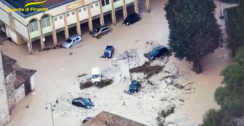 Rescue workers arrive on a dinghy boat on a flooded street after heavy rains hit the east coast of Marche region in Senigallia, Italy, September 16, 2022. Vigili del Fuoco/Handout via REUTERS ATTENTION EDITORS THIS IMAGE HAS BEEN SUPPLIED BY A THIRD PARTY. DO NOT OBSCURE LOGO.