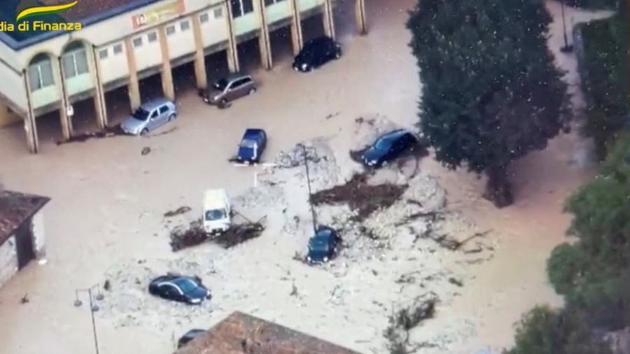 Rescue workers arrive on a dinghy boat on a flooded street after heavy rains hit the east coast of Marche region in Senigallia, Italy, September 16, 2022. Vigili del Fuoco/Handout via REUTERS ATTENTION EDITORS THIS IMAGE HAS BEEN SUPPLIED BY A THIRD PARTY. DO NOT OBSCURE LOGO.