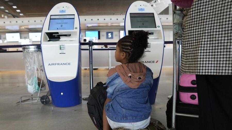 A traveler pulls her trolley Friday, Sept. 16, 2022 at Roissy Charles de Gaulle airport, north of Paris. Many domestic and some international flights were canceled in France Friday as air traffic controllers went on a national strike over pay and recruitment issues. French civil aviation authority DGAC warned that domestic traffic would be 