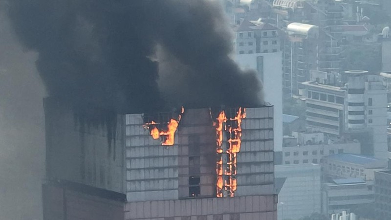 Api dan asap membubung dari gedung perkantoran setinggi 218 meter pada 16 September 2022 di Changsha, Provinsi Hunan, Tiongkok. Kebakaran besar terjadi di gedung pencakar langit di kota Changsha pada Jumat sore. (Photo by VCG/VCG via Getty Images).