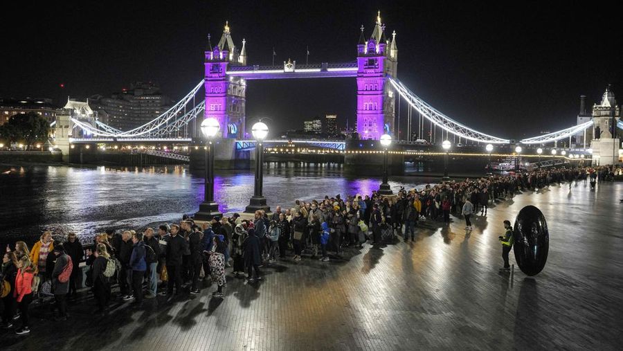 People queue in front of Tower Bridge to pay their respect to the late Queen Elizabeth II during the Lying-in State at Westminster Hall in London, early Saturday morning, Sept. 17, 2022. The Queen will lie in state in Westminster Hall for four full days before her funeral on Monday Sept. 19. (AP Photo/Martin Meissner)