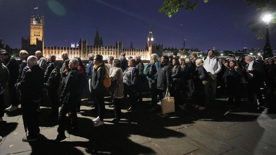 People queue in front of Tower Bridge to pay their respect to the late Queen Elizabeth II during the Lying-in State at Westminster Hall in London, early Saturday morning, Sept. 17, 2022. The Queen will lie in state in Westminster Hall for four full days before her funeral on Monday Sept. 19. (AP Photo/Martin Meissner)