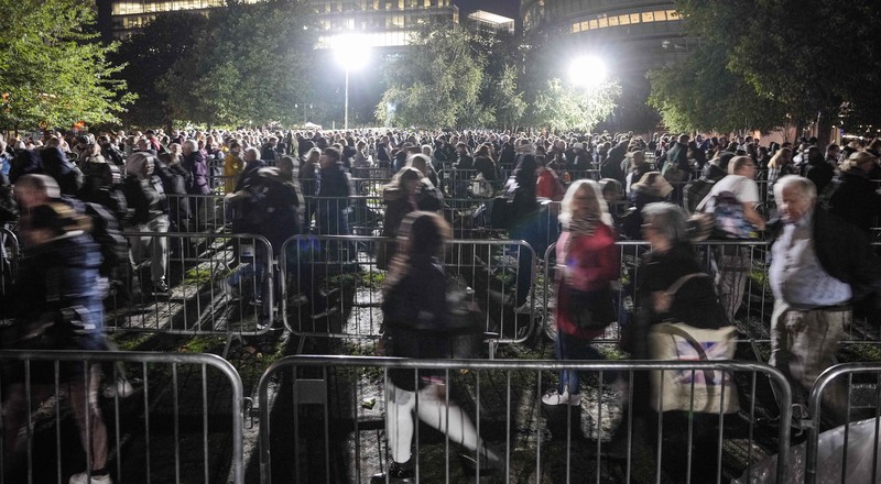 People queue in front of Tower Bridge to pay their respect to the late Queen Elizabeth II during the Lying-in State at Westminster Hall in London, early Saturday morning, Sept. 17, 2022. The Queen will lie in state in Westminster Hall for four full days before her funeral on Monday Sept. 19. (AP Photo/Martin Meissner)