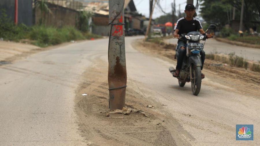 Sejumlah kendaraan melintas di jalan yang rusak di Kawasan Jalan raya Perancis Dadap, Tangerang Kamis, (22/9/2022). (CNBC Indonesia/Muhammad Sabki)