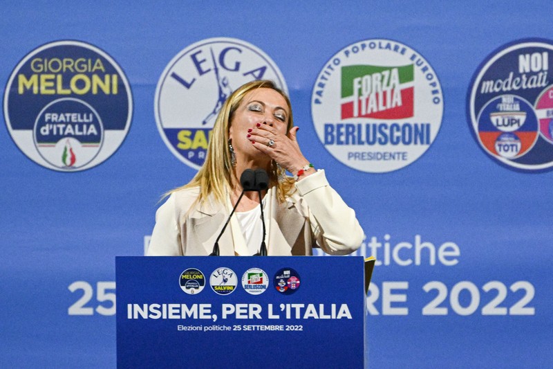 Leader of Brothers of Italy Giorgia Meloni holds a sign at the party's election night headquarters, in Rome, Italy September 26, 2022. REUTERS/Guglielmo Mangiapane     TPX IMAGES OF THE DAY