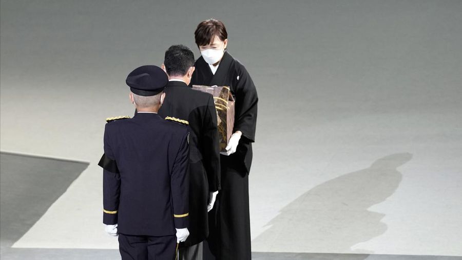 Istri mantan Perdana Menteri Jepang Shinzo Abe, Akie membawa abu suaminya saat tiba untuk memulai pemakaman kenegaraannya di Nippon Budokan di Tokyo, Jepang, Selasa (27/9/2022). Pemerintah Jepang menghabiskan biaya sebesar 1,65 miliar Yen (Rp 173 miliar) untuk pemakaman kenegaraan Abe, yang mencakup 800 juta Yen (Rp 83,9 miliar) untuk keamanan dan 600 juta Yen (Rp 62,9 miliar) untuk menjamu delegasi asing.  (Philip Fong/Pool Photo via AP)