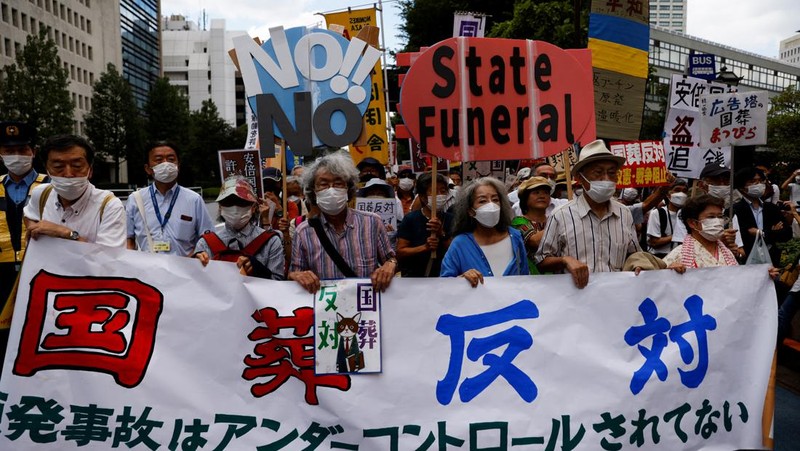 Orang-orang meninggalkan bunga dan memberi penghormatan kepada mantan Perdana Menteri Jepang Shinzo Abe di luar Nippon Budokan di Tokyo, Jepang Selasa (27/9/2022). Diperkirakan 4.300 orang akan menghadiri seremoni pemakaman kenegaraan ini, dengan sedikitnya 48 pemimpin atau pejabat tinggi pemerintahan berbagai negara, baik yang masih aktif menjabat maupun yang sudah tidak menjabat, akan turut hadir. (Nicolas Datiche/Pool Photo via AP)