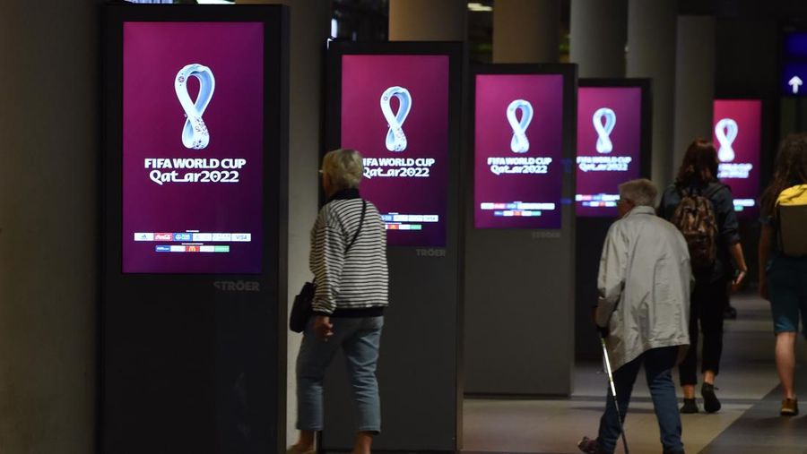 03 September 2019, Berlin: The logo of the 2022 FIFA World Cup in Qatar, published today, can be seen on electronic billboards on the ground floor of the main railway station. It is shown alternately with other advertising messages. The logo shows a stylized wide curved eight - symbolic of the eight World Cup stadiums during the final round. Photo: Paul Zinken/dpa (Photo by Paul Zinken/picture alliance via Getty Images)