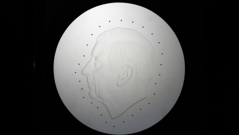 Two new coins bearing official coinage portrait of King Charles III, on the left is the new 50 pence coin, and right is the new 5 pound commemorative coin, which will be among the first coins to bear the new king's head, during a press preview in London, Thursday, Sept. 29, 2022. The likeness of the king was created by British sculptor Martin Jennings, and approved by the king. (AP Photo/Alastair Grant)