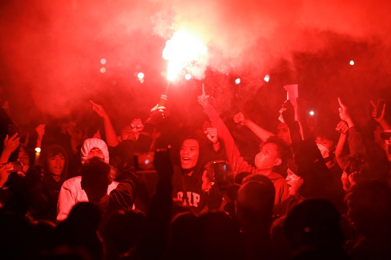Arema football club supporters take part on a vigil outside the Kanjuruhan stadium to pay condolence to the victims, after a riot and stampede following soccer match between Arema vs Persebaya outside in Malang, East Java province, Indonesia, October 2, 2022. REUTERS/Willy Kurniawan