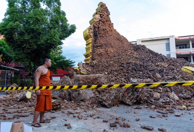 CHIANG MAI, THAILAND - 2022/09/29: A monk inspects the Ancient Buddhist pagoda a 500-year-old Buddhist pagoda at Sri Suphan Temple in Muang district of Chiang Mai that collapsed due to the heavy rains. Ancient Buddhist pagoda at Sri Suphan Temple, collapsed after being worn out by rain throughout the week, prompting officials from the Fine Arts Department to rush to assess the damage. (Photo by Pongmanat Tasiri/SOPA Images/LightRocket via Getty Images)