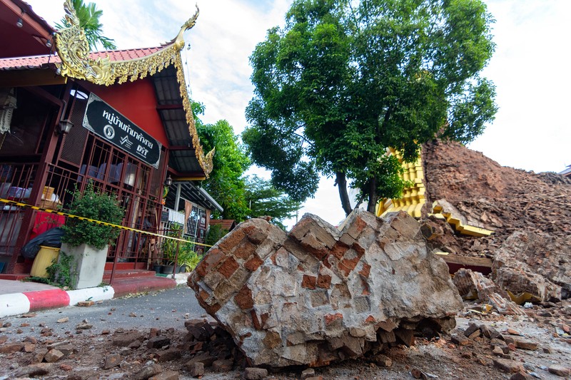 1243608029 CHIANG MAI, THAILAND - 2022/09/29: A monk inspects the Ancient Buddhist pagoda a 500-year-old Buddhist pagoda at Sri Suphan Temple in Muang district of Chiang Mai that collapsed due to the heavy rains. Ancient Buddhist pagoda at Sri Suphan Temple, collapsed after being worn out by rain throughout the week, prompting officials from the Fine Arts Department to rush to assess the damage. (Photo by Pongmanat Tasiri/SOPA Images/LightRocket via Getty Images)