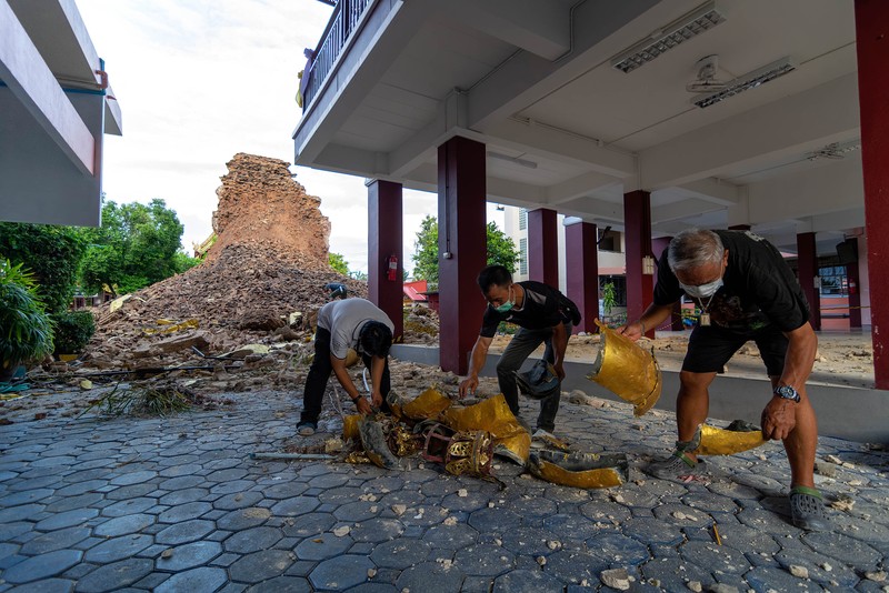 1243608029 CHIANG MAI, THAILAND - 2022/09/29: A monk inspects the Ancient Buddhist pagoda a 500-year-old Buddhist pagoda at Sri Suphan Temple in Muang district of Chiang Mai that collapsed due to the heavy rains. Ancient Buddhist pagoda at Sri Suphan Temple, collapsed after being worn out by rain throughout the week, prompting officials from the Fine Arts Department to rush to assess the damage. (Photo by Pongmanat Tasiri/SOPA Images/LightRocket via Getty Images)