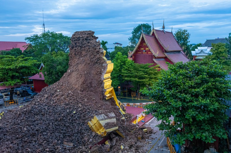 1243608029 CHIANG MAI, THAILAND - 2022/09/29: A monk inspects the Ancient Buddhist pagoda a 500-year-old Buddhist pagoda at Sri Suphan Temple in Muang district of Chiang Mai that collapsed due to the heavy rains. Ancient Buddhist pagoda at Sri Suphan Temple, collapsed after being worn out by rain throughout the week, prompting officials from the Fine Arts Department to rush to assess the damage. (Photo by Pongmanat Tasiri/SOPA Images/LightRocket via Getty Images)