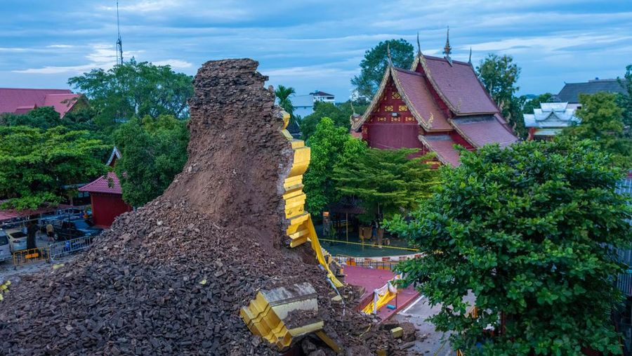 CHIANG MAI, THAILAND - 2022/09/29: A monk inspects the Ancient Buddhist pagoda a 500-year-old Buddhist pagoda at Sri Suphan Temple in Muang district of Chiang Mai that collapsed due to the heavy rains. Ancient Buddhist pagoda at Sri Suphan Temple, collapsed after being worn out by rain throughout the week, prompting officials from the Fine Arts Department to rush to assess the damage. (Photo by Pongmanat Tasiri/SOPA Images/LightRocket via Getty Images)