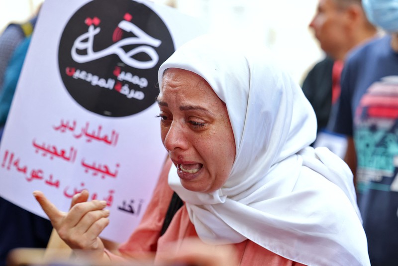 Demonstrators carry banners during a protest organised by 