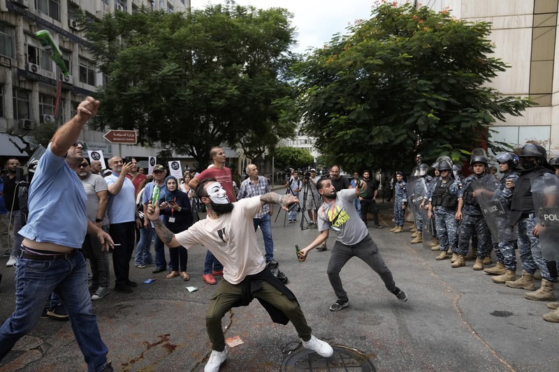 Demonstrators carry banners during a protest organised by 