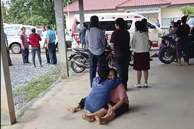 In this image taken from video, officials enter the site of an attack at a daycare canter, Thursday, Oct. 6, 2022, in the town of Nongbua Lamphu, north eastern Thailand. More than 30 people, primarily children, were killed Thursday when a gunman opened fire the childcare center authorities said. (TPBS via AP)
