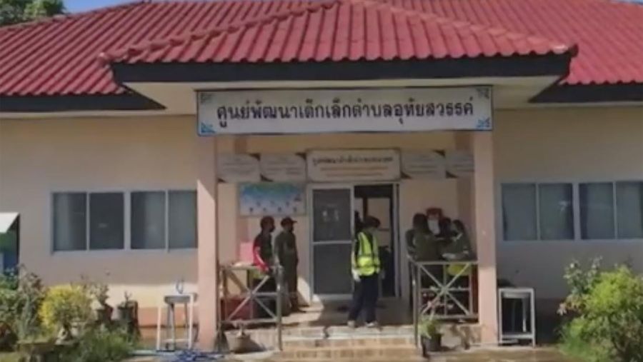 In this image taken from video, officials enter the site of an attack at a daycare canter, Thursday, Oct. 6, 2022, in the town of Nongbua Lamphu, north eastern Thailand. More than 30 people, primarily children, were killed Thursday when a gunman opened fire the childcare center authorities said. (TPBS via AP)