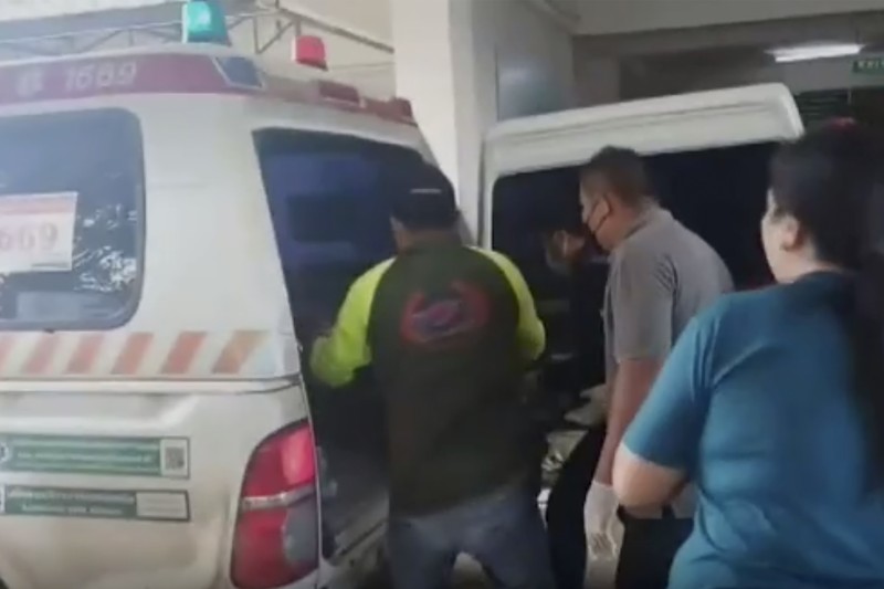 In this image taken from video, officials enter the site of an attack at a daycare canter, Thursday, Oct. 6, 2022, in the town of Nongbua Lamphu, north eastern Thailand. More than 30 people, primarily children, were killed Thursday when a gunman opened fire the childcare center authorities said. (TPBS via AP)